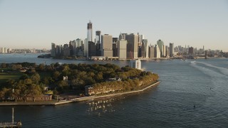 AX90_111 - 4K aerial stock footage Flying by Lower Manhattan, Governors Island, New York, New York, sunrise
