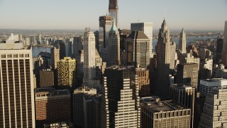 AX90_115 - 4K aerial stock footage Approaching Lower Manhattan skyscrapers, New York, New York, sunrise