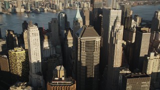 AX90_116 - 4K aerial stock footage Flying by Lower Manhattan skyscrapers, New York, New York, sunrise