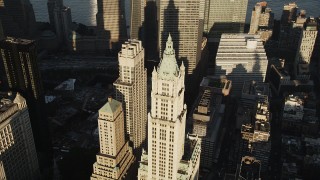 AX90_119 - 4K aerial stock footage Orbiting Woolworth Building, Lower Manhattan, New York, New York, sunrise