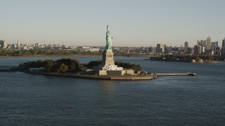 AX90_149 - 4K aerial stock footage Approaching Statue of Liberty, Liberty Island, New York, New York, sunrise