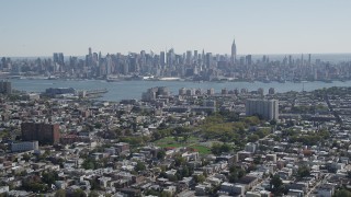 AX91_001 - 4K stock footage aerial video of the Midtown Manhattan skyline and Hudson River, New York, seen from Union City, New Jersey