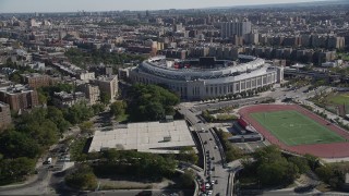 AX91_018 - 4K aerial stock footage tilt from Macombs Dam Bridge, reveal Yankee Stadium, The Bronx, New York