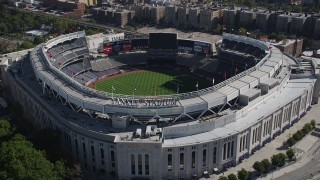 AX91_019 - 4K aerial stock footage of approaching Yankee Stadium, tilting to baseball field, The Bronx, New York