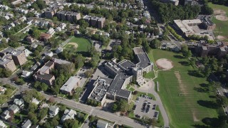 AX91_031 - 4K aerial stock footage of flying over suburban neighborhoods, Isaac E. Young Middle School, New Rochelle, New York
