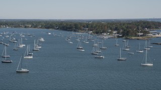 AX91_041 - 4K aerial stock footage of flying by sailboats near the coast, Rye, New York