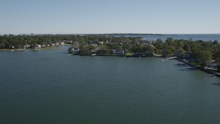 AX91_065 - 4K aerial stock footage of flying by oceanfront homes on the coast in Greenwich, Connecticut