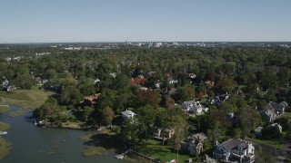 AX91_067 - 4K aerial stock footage of flying over oceanfront homes, suburban neighborhoods, Greenwich, Connecticut
