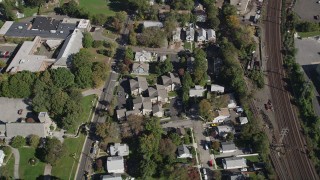 AX91_080 - 4K aerial stock footage approach suburban homes by railroad tracks, Stamford, Connecticut