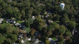AX91_094 - 4K aerial stock footage of tilting to suburban homes and neighborhoods with trees in Norwalk, Connecticut