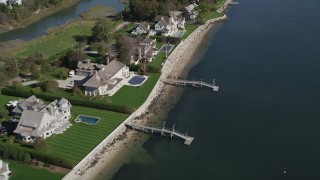 AX91_100 - 4K aerial stock footage of flying by ocean and beachfront homes with docks, Norwalk, Connecticut