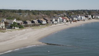 AX91_114 - 4K aerial stock footage of flying by a row of beachfront homes, Fairfield, Connecticut
