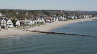 AX91_115 - 4K aerial stock footage of flying by a row of beachfront homes, Fairfield, Connecticut