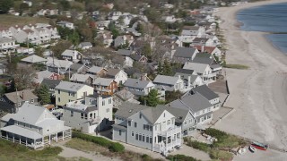 AX91_117 - 4K aerial stock footage of flying by homes on the beach in Fairfield, Connecticut
