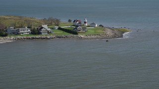 AX91_122 - 4K aerial stock footage of tilting up from the water, revealing Stratford Point Light in Stratford, Connecticut