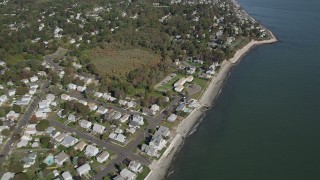 AX91_129 - 4K aerial stock footage of flying by homes near the beach in Milford, Connecticut