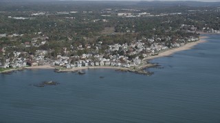 AX91_130 - 4K aerial stock footage of flying by neighborhoods near the beach in Milford, Connecticut