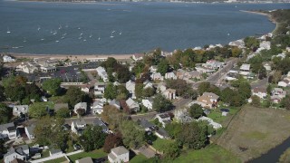 AX91_134 - 4K aerial stock footage of flying by homes near the beach and Morris Cove, New Haven, Connecticut