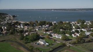 AX91_135 - 4K aerial stock footage of flying by homes and Morris Cove, New Haven, Connecticut