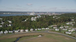 AX91_138 - 4K aerial stock footage of flying by suburban homes on a small hill in New Haven, Connecticut