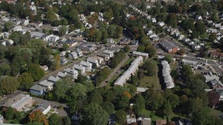 AX91_139 - 4K aerial stock footage of flying over suburban homes in autumn, New Haven, Connecticut