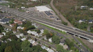 AX91_140 - 4K aerial stock footage fly over suburban homes, pan across Connecticut Turnpike freeway, New Haven, Connecticut
