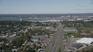 AX91_141 - 4K aerial stock footage of flying by Connecticut Turnpike freeway with view of an oil refinery, New Haven, Connecticut