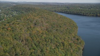 AX91_143 - 4K aerial stock footage of approaching forests on the shore, autumn, Lake Saltonstall, Connecticut