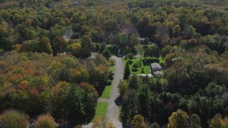 AX91_172 - 4K aerial stock footage video of flying over forest and homes in autumn, Guilford, Connecticut