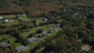 AX91_184 - 4K aerial stock footage approach neighborhoods near forests in autumn, Guilford, Connecticut