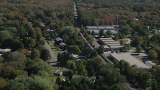AX91_190 - 4K aerial stock footage of tracking a passenger train through trees, autumn, Guilford, Connecticut