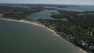 AX91_193 - 4K aerial stock footage of approaching homes and beach near Hashamomuck Pond, Southold, New York