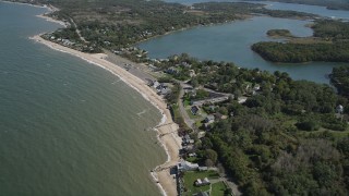 AX91_194 - 4K aerial stock footage video of flying by homes on the beach near Hashamomuck Pond, Southold, New York