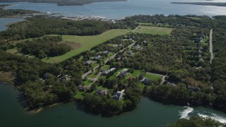 AX91_195 - 4K aerial stock footage of approaching upscale, waterfront homes in Southold, New York