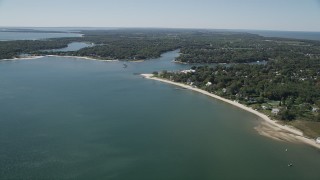 AX91_199 - 4K aerial stock footage of flying by coastal neighborhoods, Southold, New York