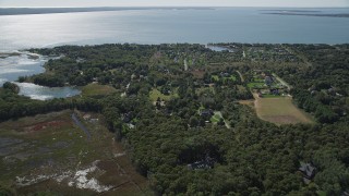 AX91_201 - 4K aerial stock footage of approaching upscale homes on the coast in Southold, New York