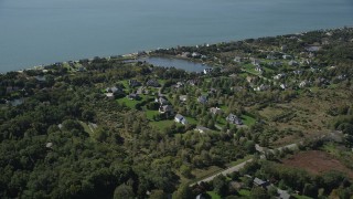 AX91_202 - 4K aerial stock footage of flying by upscale homes in a coastal neighborhood, Southold, New York