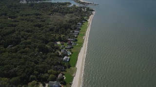 AX91_204 - 4K aerial stock footage of flying over beachfront homes, revealing Wooley Pond, Southampton, New York