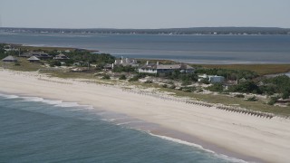 AX91_220 - 4K aerial stock footage of flying by beachfront mansions, Southampton, New York