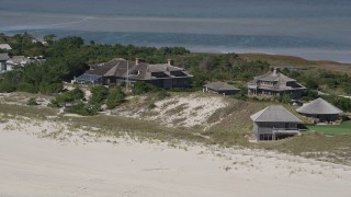 AX91_222 - 4K aerial stock footage of passing by upscale beach homes, Southampton, New York