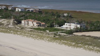 AX91_223 - 4K aerial stock footage of flying by two beachfront mansions, Southampton, New York