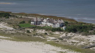 AX91_225 - 4K aerial stock footage of flying by an isolated beachfront mansion, Southampton, New York