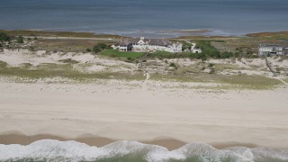 AX91_226 - 4K aerial stock footage of flying by a beachfront mansion, Southampton, New York