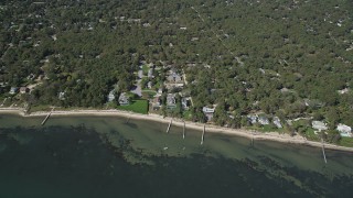 AX91_233 - 4K aerial stock footage of approaching beachside homes with docks, Hampton Bays, New York