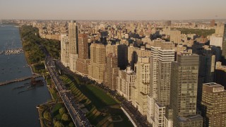 AX93_011 - 4K aerial stock footage Flying by Henry Hudson Parkway, Upper West Side, New York, New York, sunset