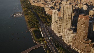AX93_012 - 4K aerial stock footage of Henry Hudson Parkway, Upper West Side, Riverside Park, New York, sunset