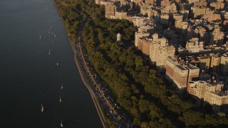 AX93_014 - 4K aerial stock footage Flying by Henry Hudson Parkway, Upper West Side, New York, New York, sunset