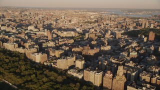 AX93_015 - 4K aerial stock footage Flying by apartment buildings, Upper West Side, New York, New York, sunset