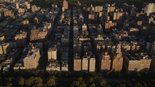AX93_016 - 4K aerial stock footage Flying by apartment buildings, Upper West Side, New York, New York, sunset