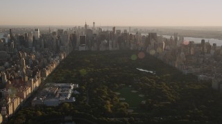 AX93_021 - 4K stock footage aerial video Jacqueline Kennedy Onassis Reservoir, Central Park, Midtown, New York, sunset